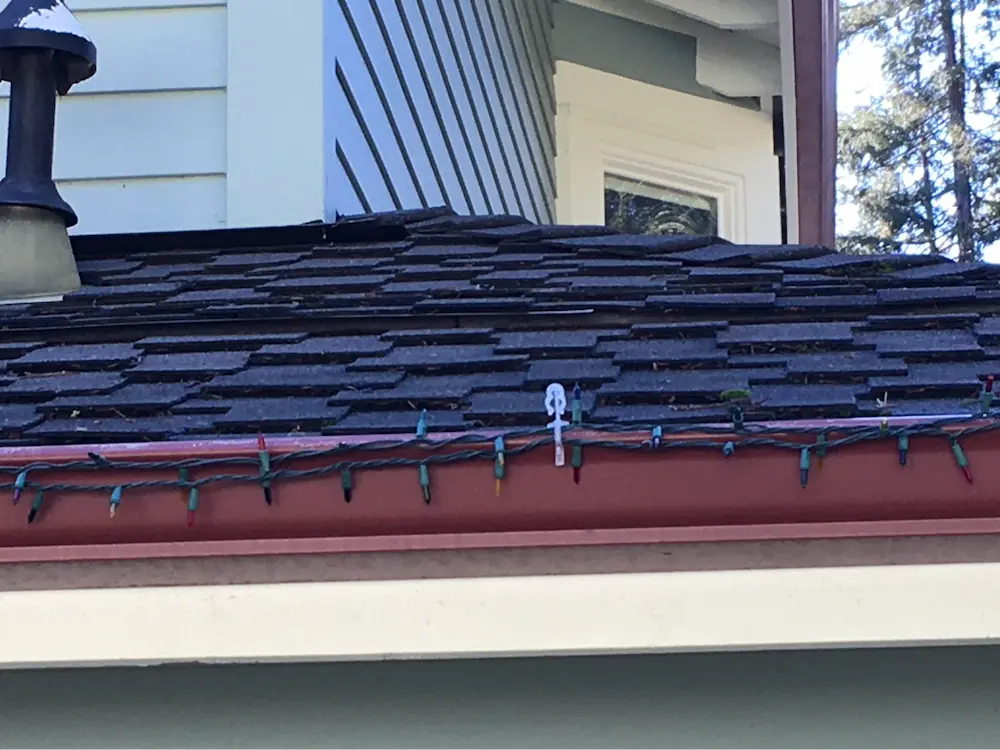This low profile off-ridge vent is subtle and runs the full width of the photo just below the stovepipe.  This vent was manufactured by <a href="https://ohagin.com/">O’Hagin</a> and is not a Chapter 7A compliant vent.