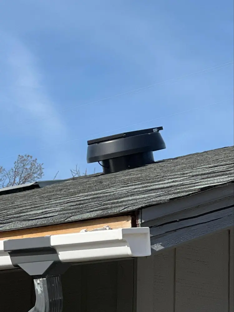 An off-ridge solar-powered fan vent that provides active ventilation of the attic space.