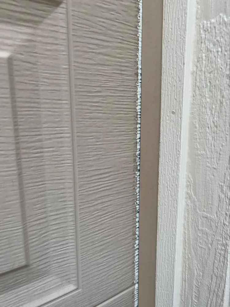 Metal garage door, at the right hand jamb.