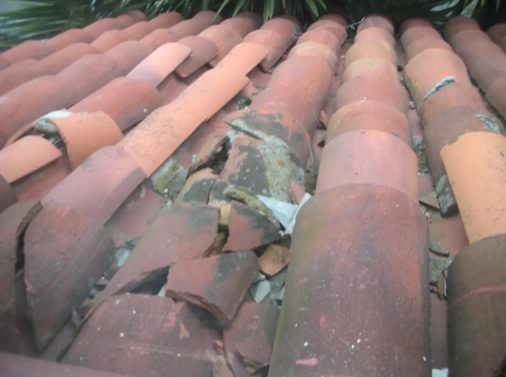 Barrel tile roof with crushed tiles in poor condition. The potential for ember penetration into gaps between the broken tiles means these tiles (or the entire roof) should be replaced.