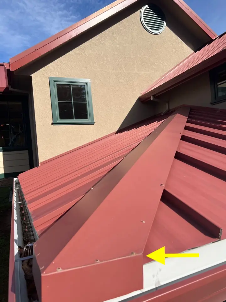 Standing seam metal roof hip rafter covering, which has a 3x2 inch opening at the roof edge (not shown) in which a vacated wasp nest had been built.
